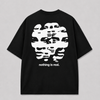 Achterkant van het zwarte NOTHING IS REAL T-shirt van FAKESNIFF, met een wit vervormd gezicht in horizontale banen, met de tekst 'nothing is real.'