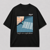 Zwart oversized HIGH ON CAPITALISM T-shirt van FAKESNIFF, print 'high on capitalism': een hand trekt met een stift lijnen uit een barcode