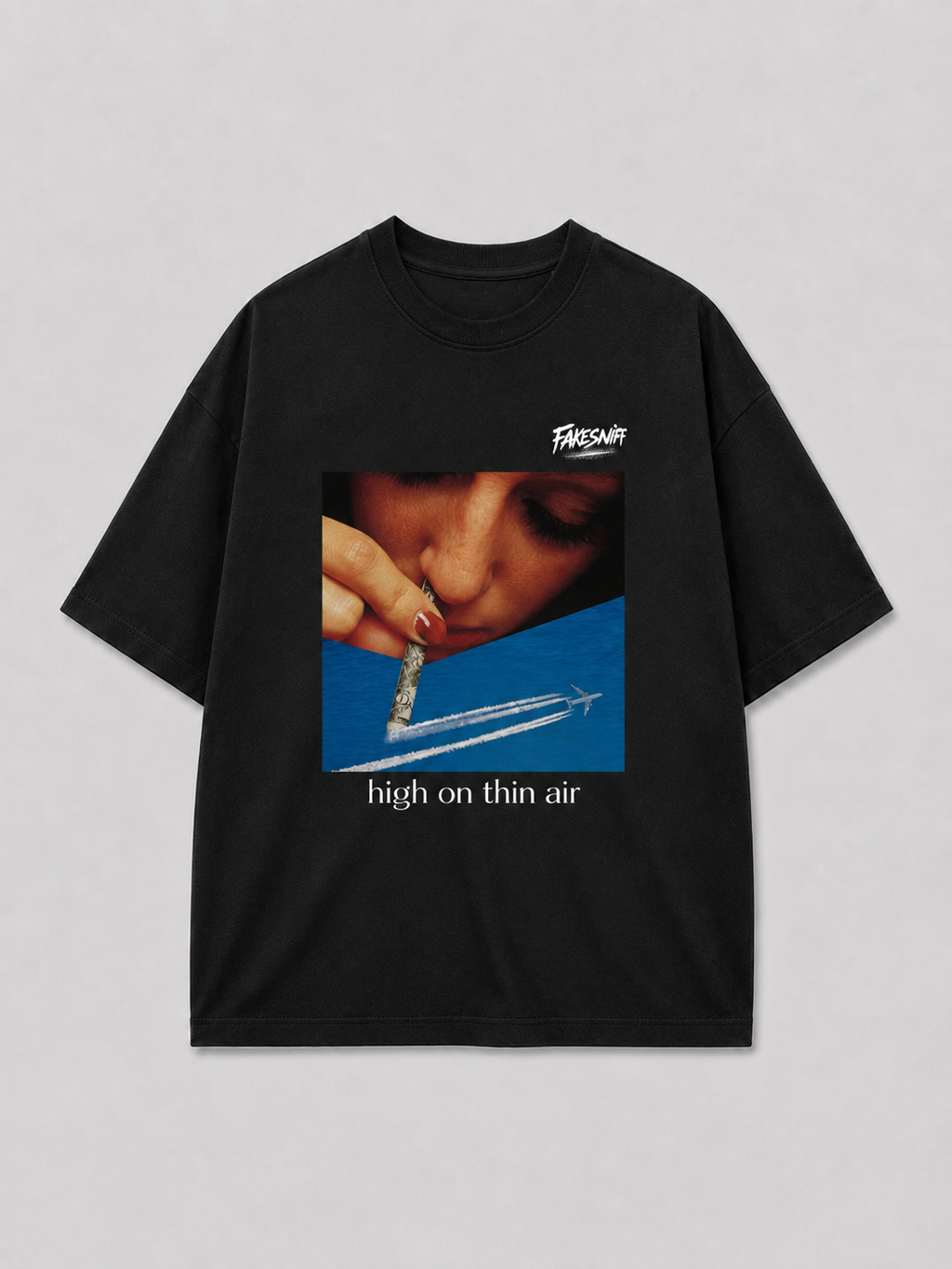 Zwart oversized HIGH ON THIN AIR T-shirt van FAKESNIFF, print 'high on thin air': een vrouw snuift door een opgerold bankbiljet boven de condensstreep van een vliegtuig