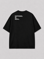 Achterkant van een zwart oversized FAKESNIFF T-shirt, met NOTHING. IS. REAL. over de schouders gedrukt